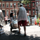A woman walks away from a free weekly food pantry in the Bronx on July 11, 2018, in New York City